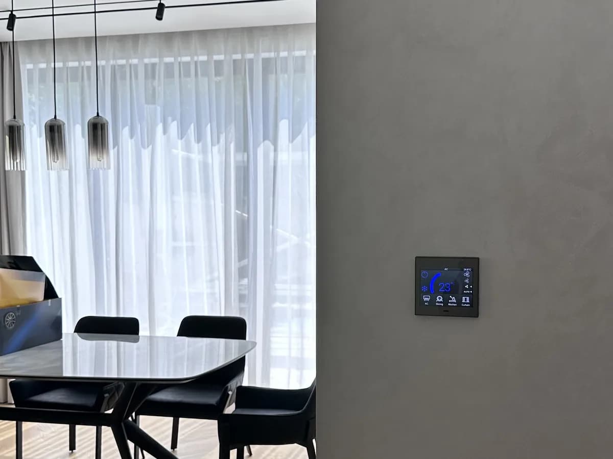 Dining area of the Jumeirah villa with its KNX touch panel for air conditioning, lighting and curtains