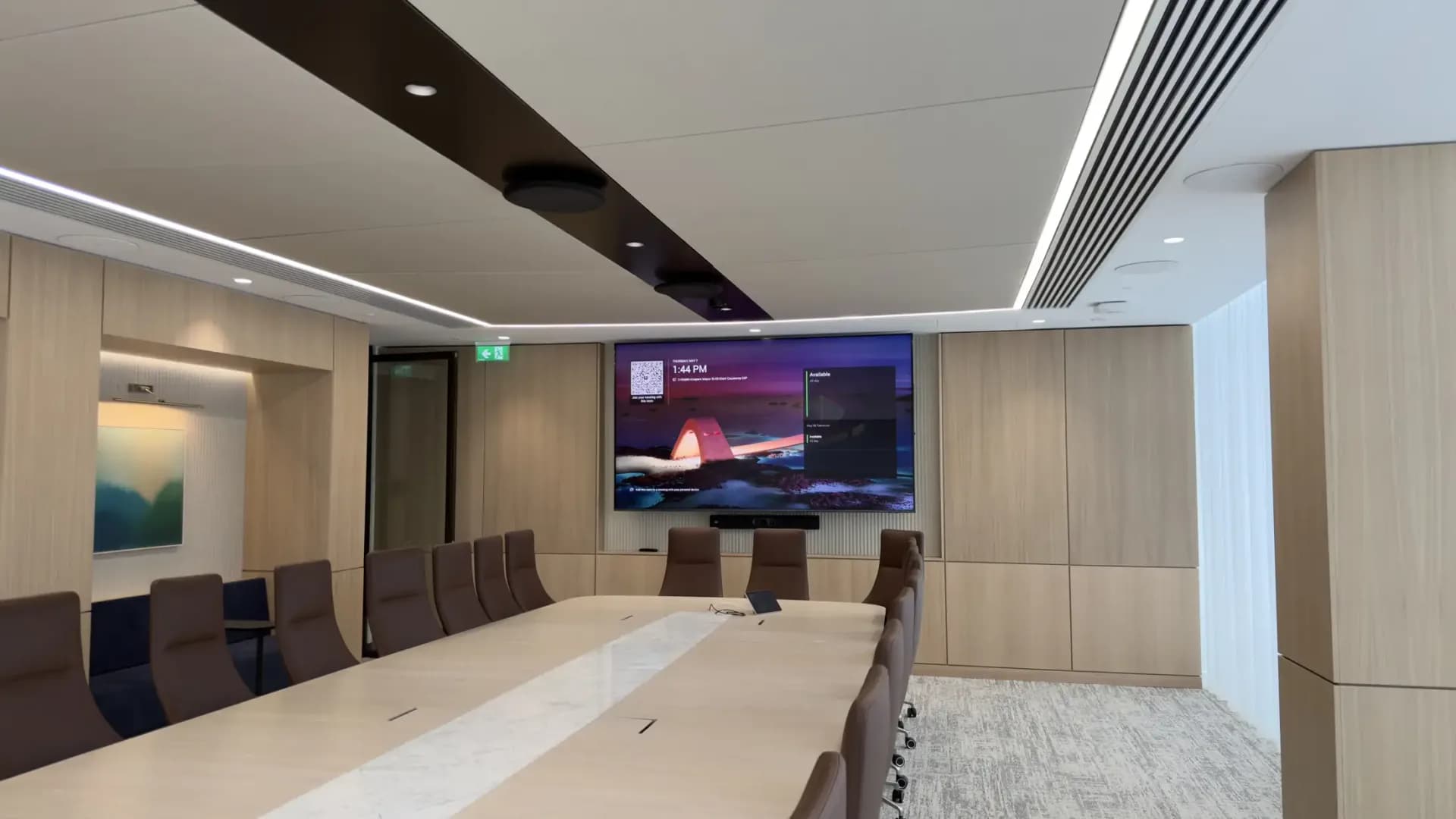 Boardroom with a large video wall and a long conference table