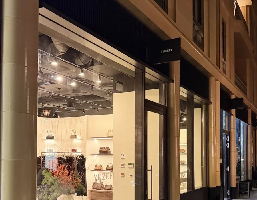 Shopfront lit at night with illuminated window displays
