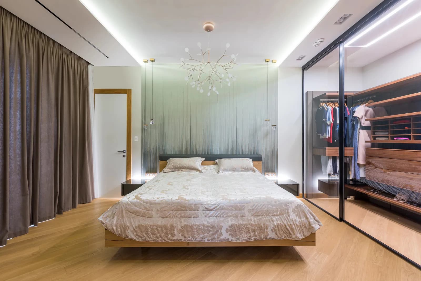 Bedroom with sheer and blackout curtains and warm bedside lighting