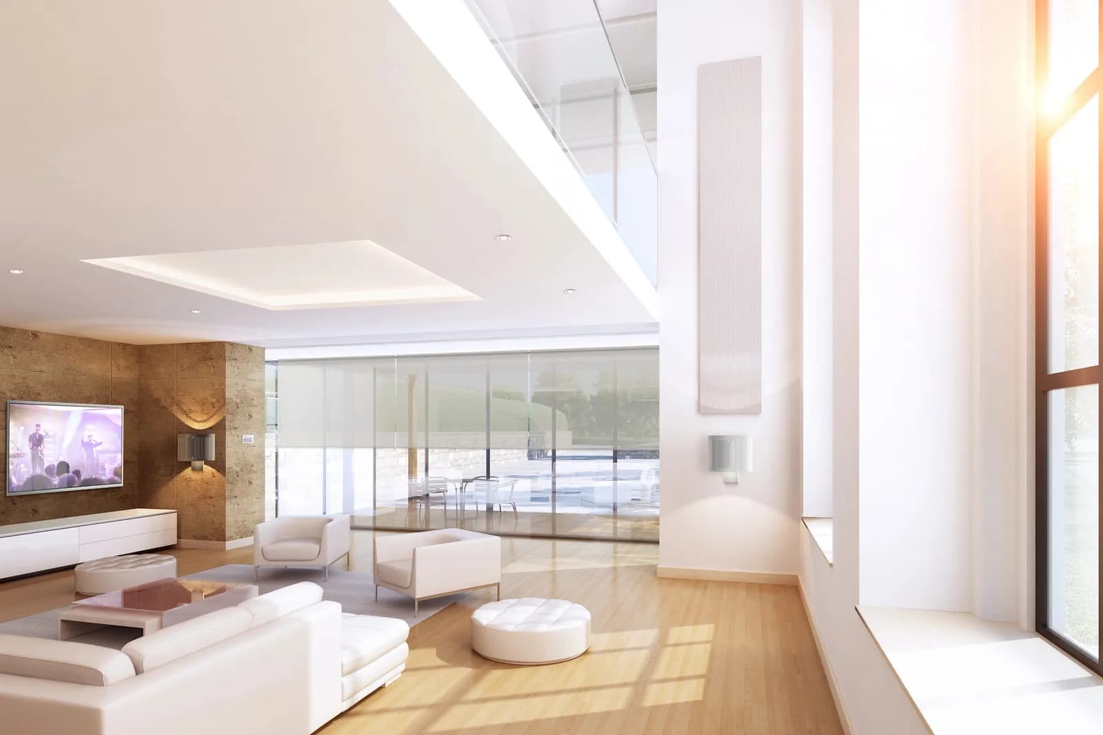 Double-height living room with a wall touch screen and concealed speakers