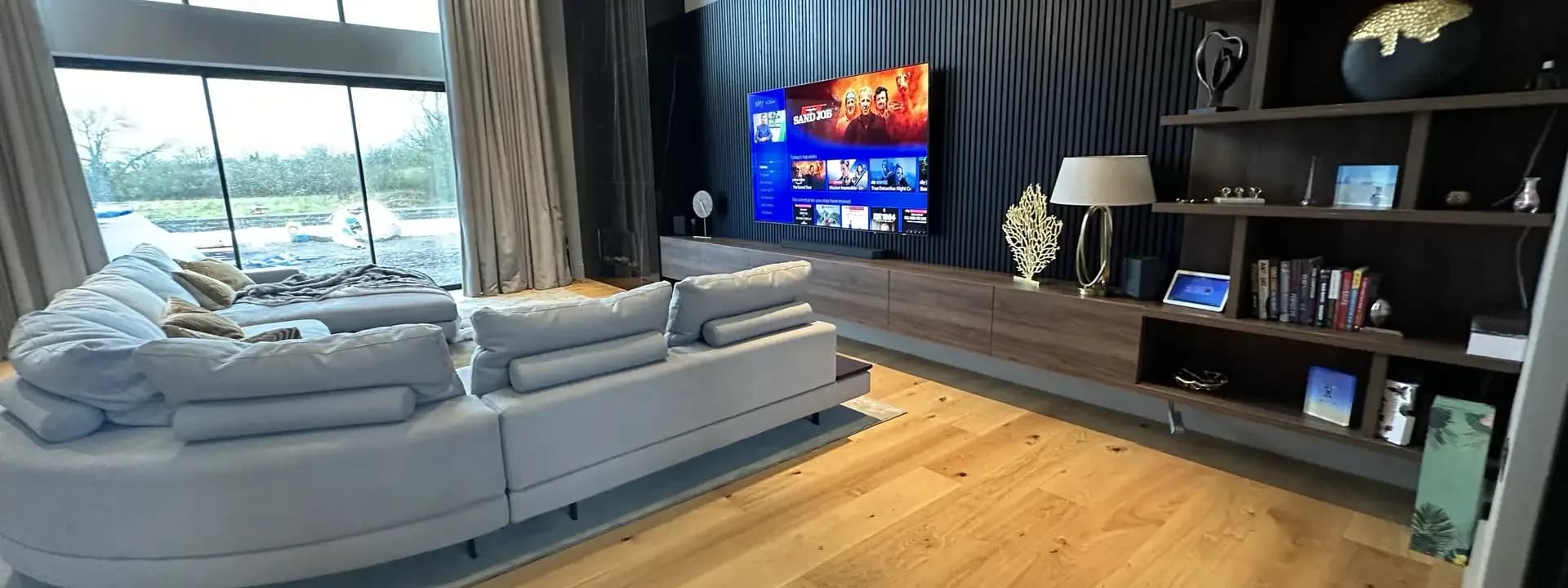 Living room with concealed audio and a large sofa